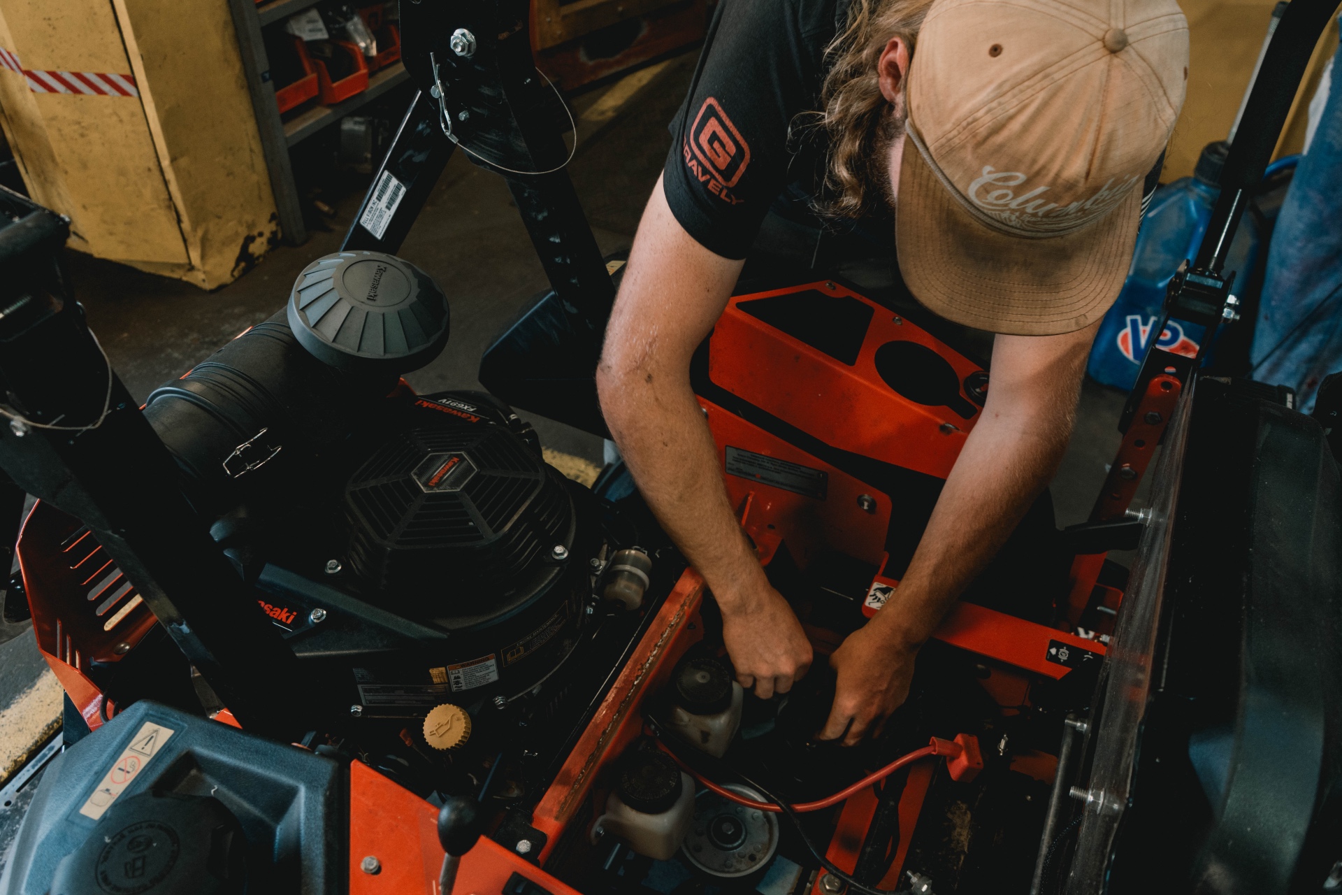 Technician working on a Gravely zero-turn mower engine