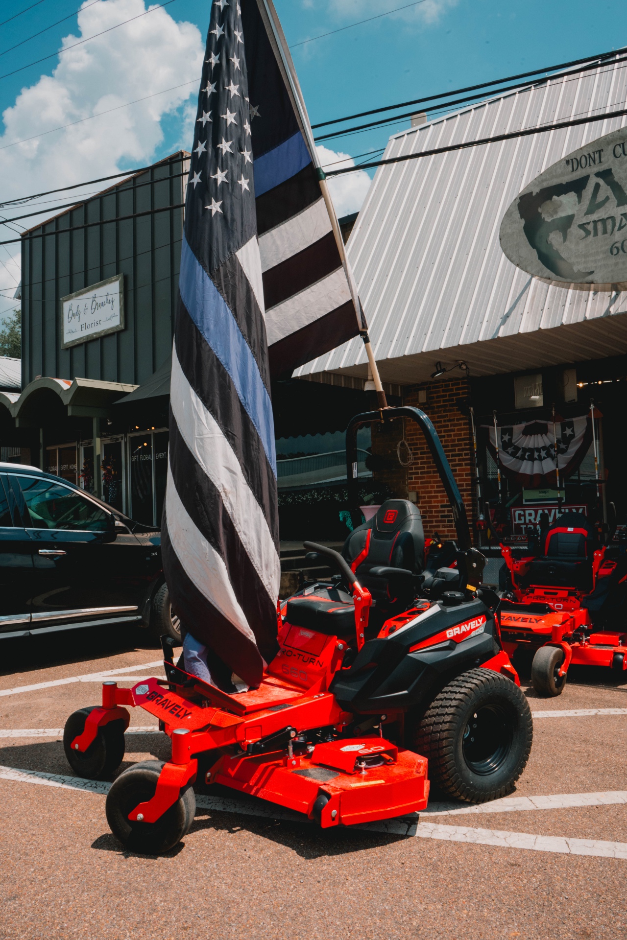 Gravely Pro-Turn zero-turn mowers in front of the shop